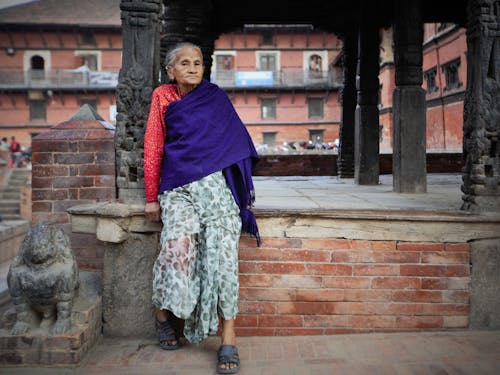 An Elderly Woman Wearing a Purple Scarf