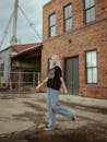 Woman Walking Across Empty Lot