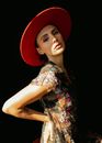 Portrait of Woman in Floral Print Dress and Red Hat