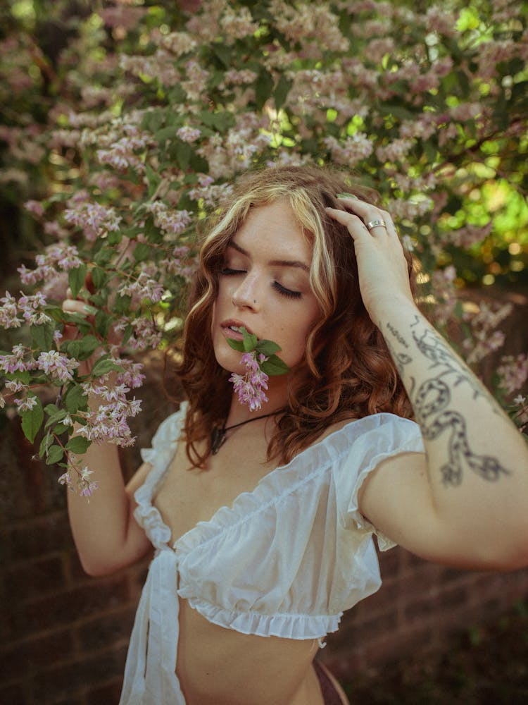 Portrait Of A Beautiful Woman With Flowers On Her Mouth