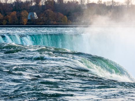 Captivating close-up of Niagara Falls showcasing turquoise water and mist, recognizable landmark.