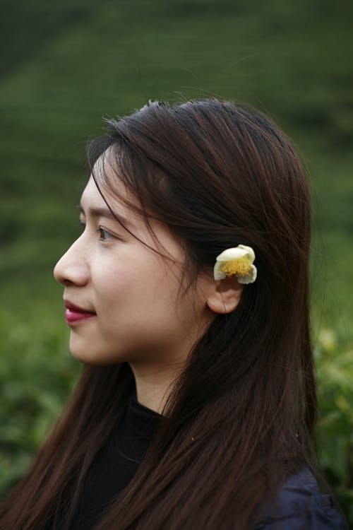 Side View of a Woman with a Flower on Her Hair