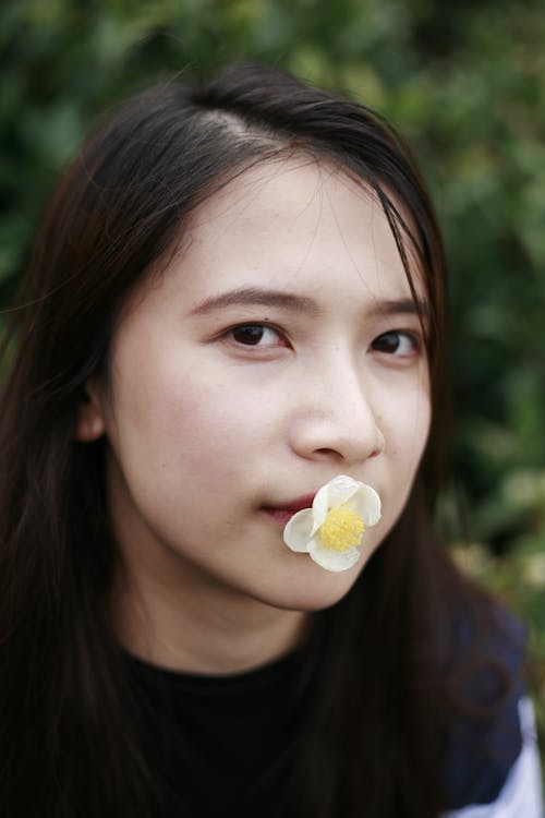 A Woman with a Flower on Her Mouth