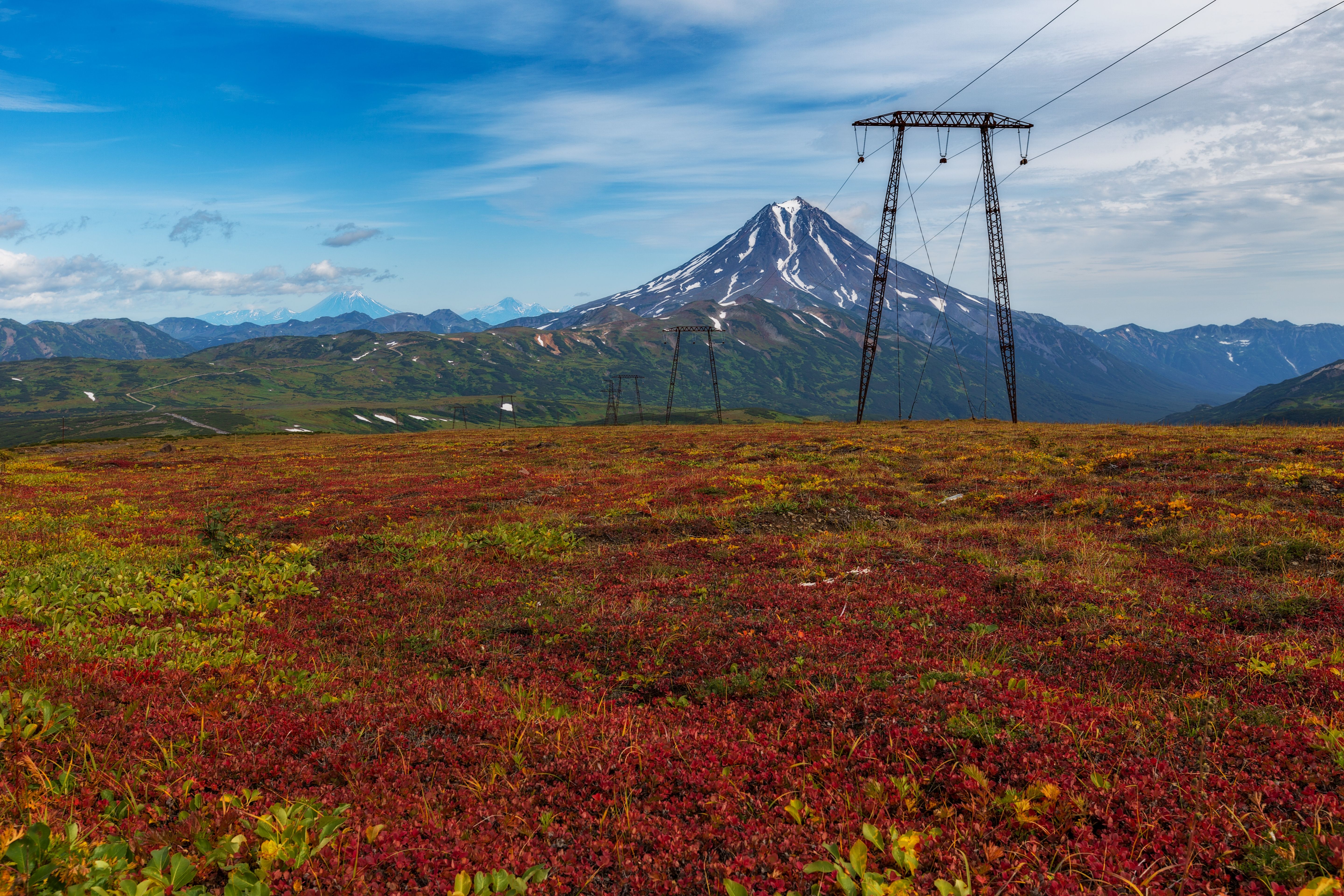 High voltage power lines against mountains in sunset · Free Stock Photo