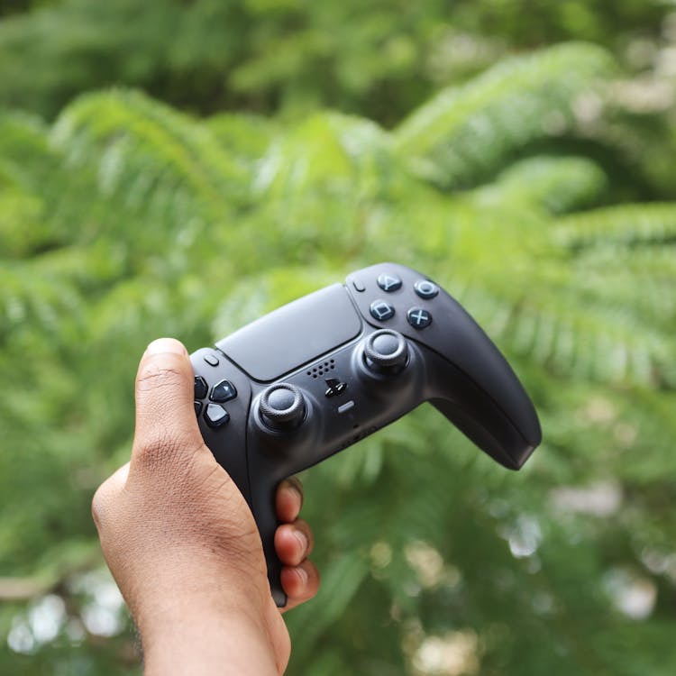 Person Holding Black Sony Ps4 Controller