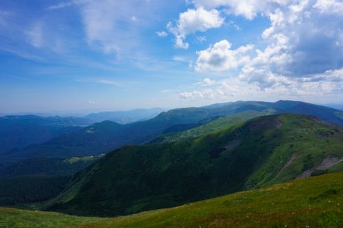 Free Expansive view of the lush Carpathian Mountains under a bright blue sky in Zakarpattia Oblast, Ukraine. Stock Photo