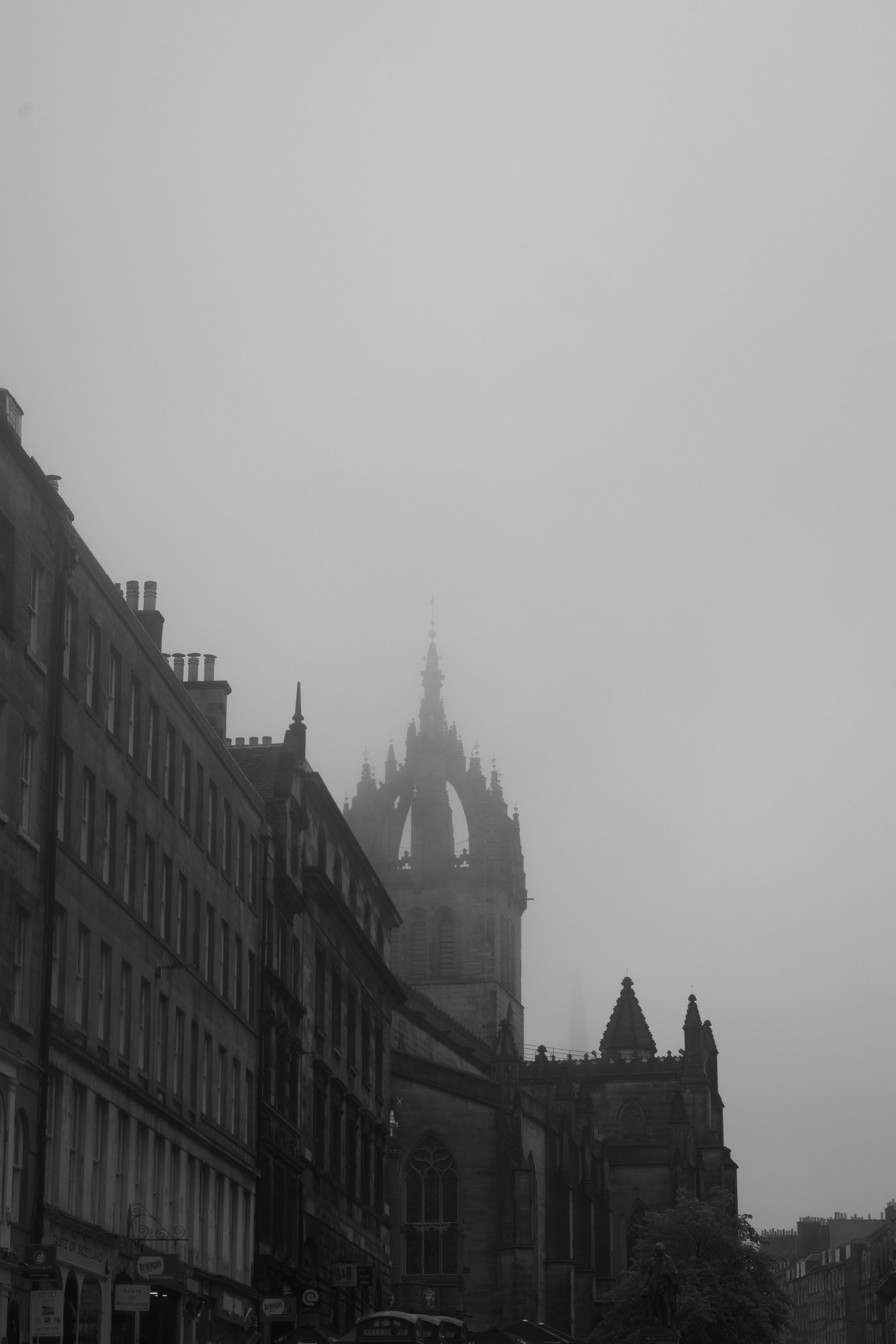 Black and white image of St. Giles Cathedral obscured by mist in Edinburgh, Scotland.