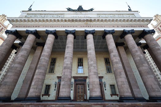Majestic facade of Moscow State University with imposing columns in daylight.