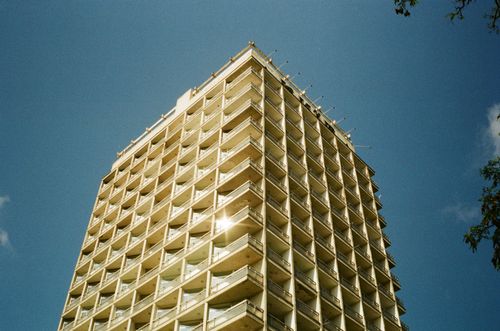 Free Low-angle view of a modern high-rise in Kyiv with a clear blue sky backdrop. Stock Photo