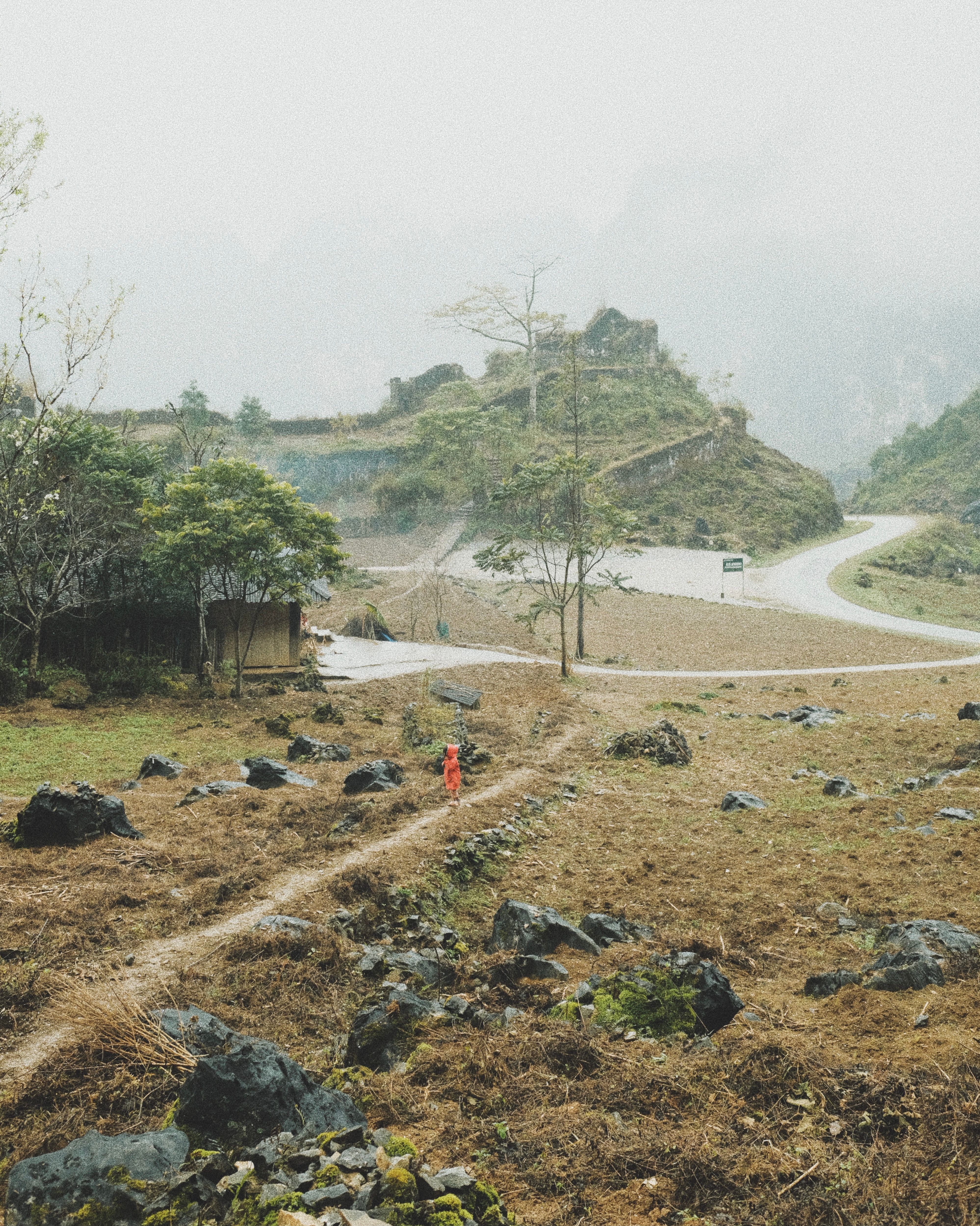 Peaceful rural scene in Hà Giang, Vietnam, with hills and winding paths.