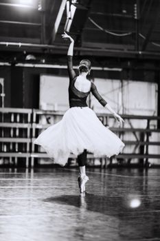 Black and white photo of a ballerina performing gracefully with elegance and poise.