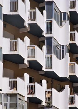 Close-up of a modern building facade featuring unique geometric balconies.