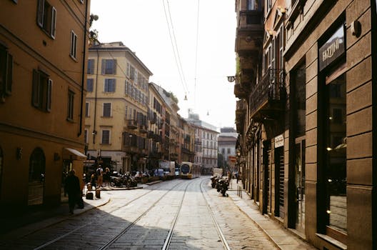 Picturesque European street scene featuring classic architecture and tram lines at daytime.