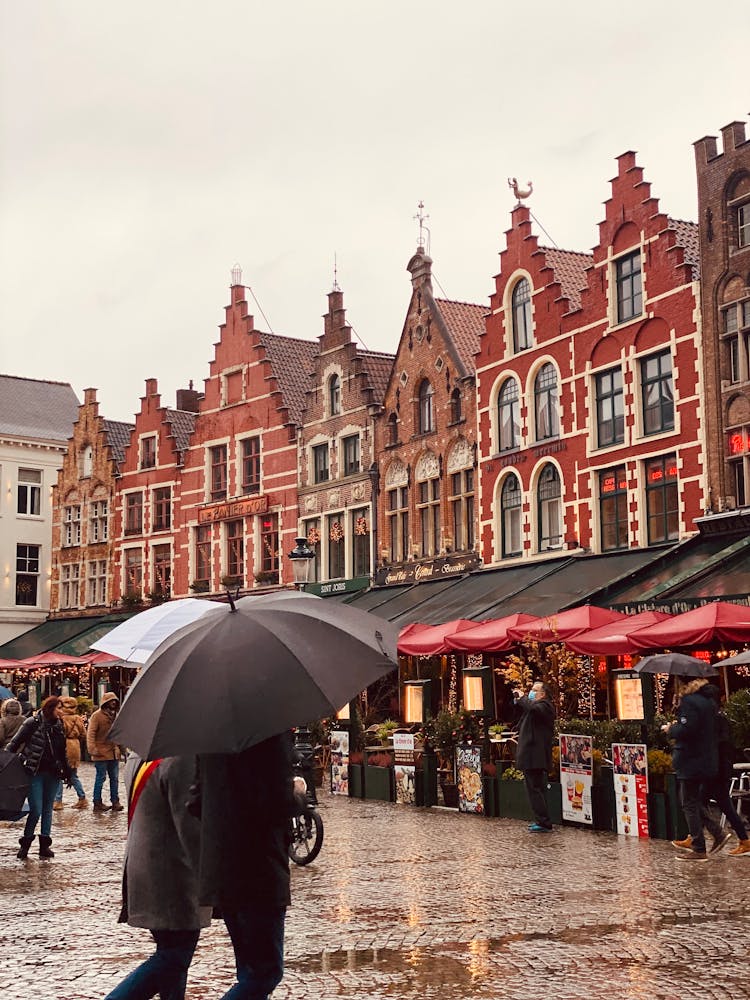 People Walking Near Restaurants On Old Market Square In Town In Christmas