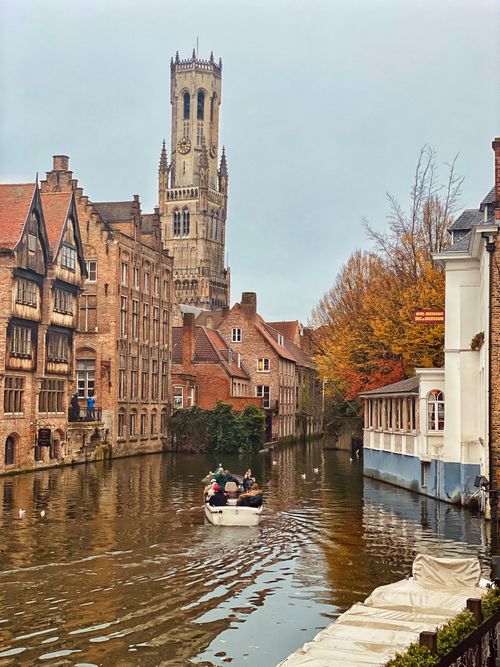 Free Historic canal and iconic Belfry tower in Bruges, Belgium, during autumn. Stock Photo