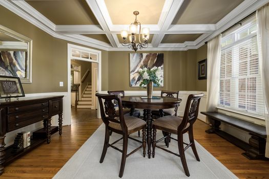 Spacious dining room with classic wooden furniture and elegant interior design.