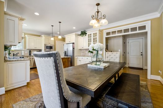 Bright modern kitchen and dining area with elegant decor and wooden furniture highlighting style and comfort.