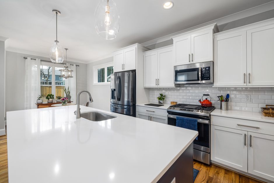 coastal-style kitchen with light-colored cabinets and a large island - kitchen remodel in fort lauderdale coastal-style kitchen with light-colored cabinets and a large island - kitchen remodel in fort lauderdale
