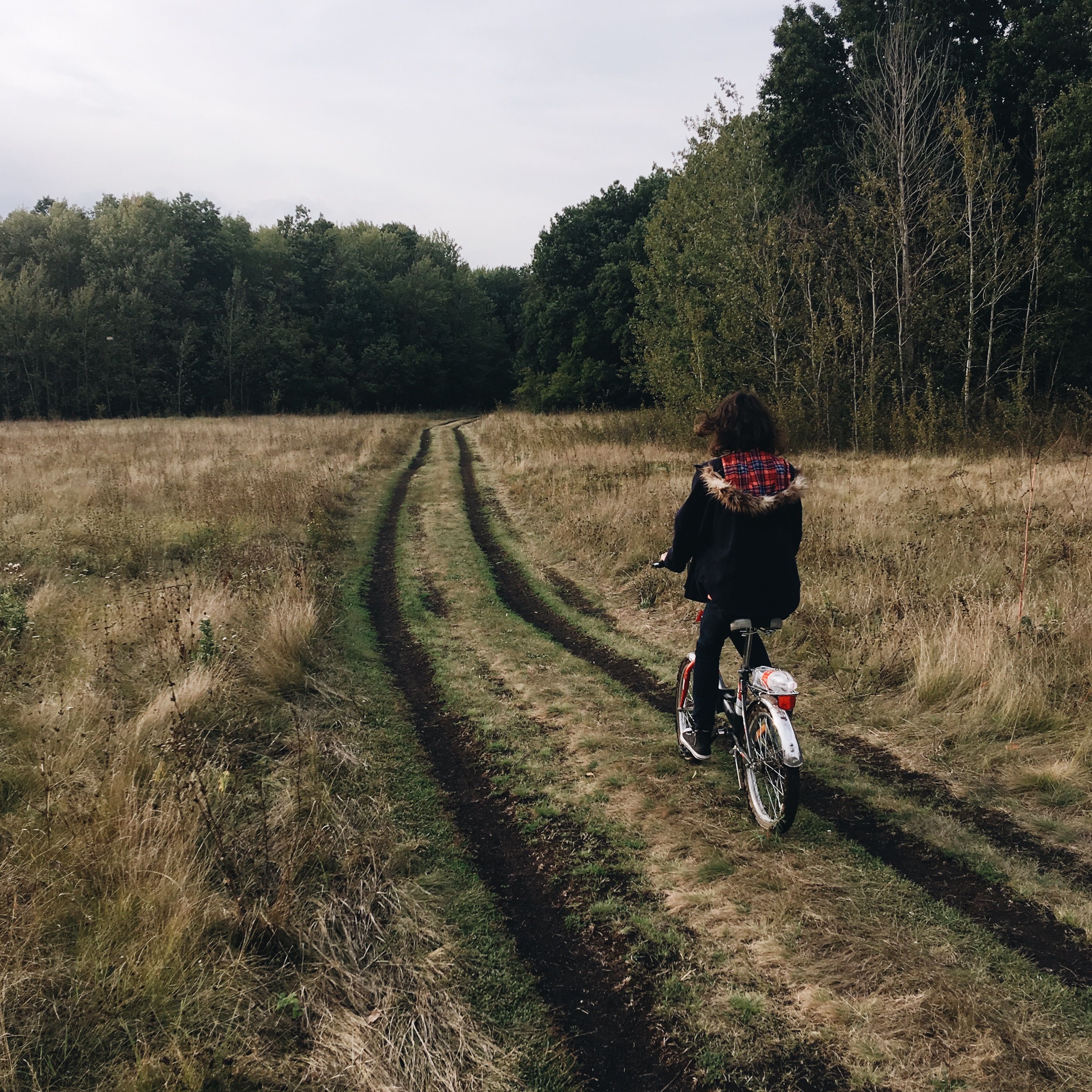 Girl on Bicycle on Village Road