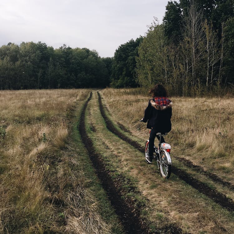 Girl On Bicycle On Village Road