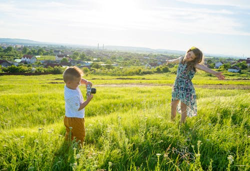 Little Boy taking a  Photo of his Sister 