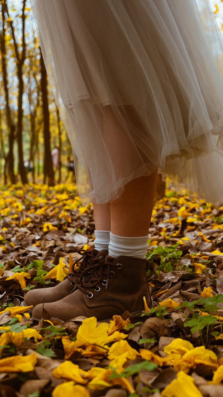 Woman In Tulle Skirt And Boots Standing In Autumn Forest