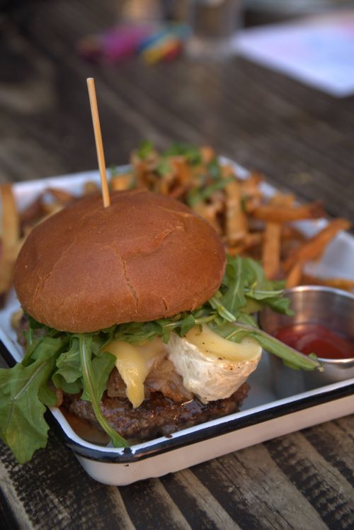Free Delicious cheese burger with arugula served with fries and ketchup. Stock Photo