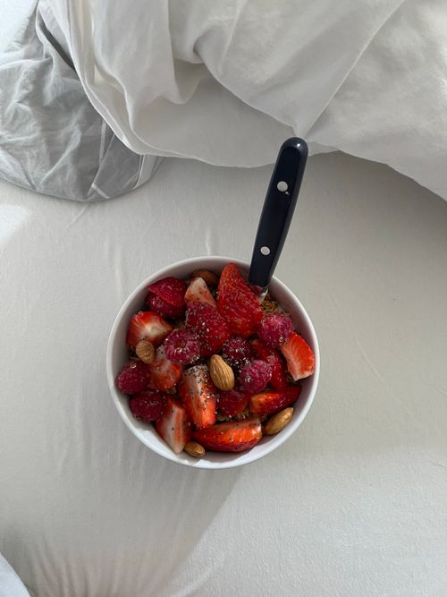 Free Overhead view of a fresh fruit and nut salad in a bowl with strawberries and almonds. Stock Photo