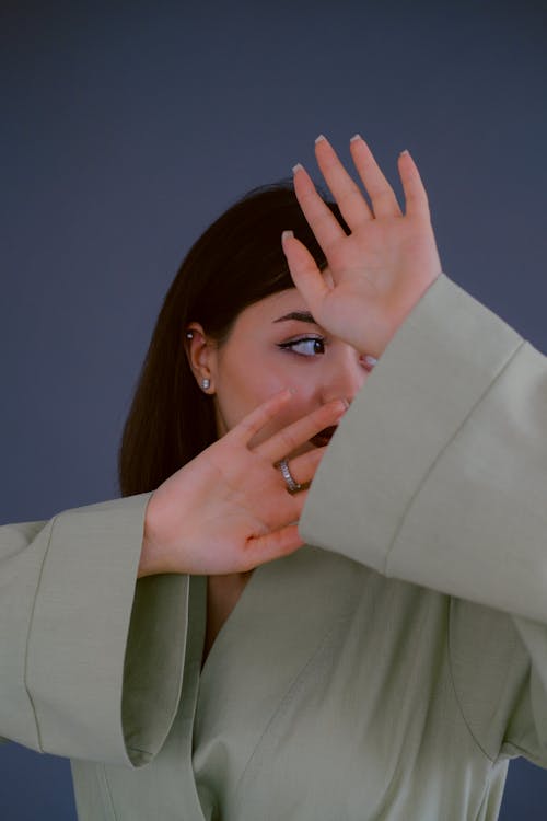 Woman Blocking the View of Her Face with Hands