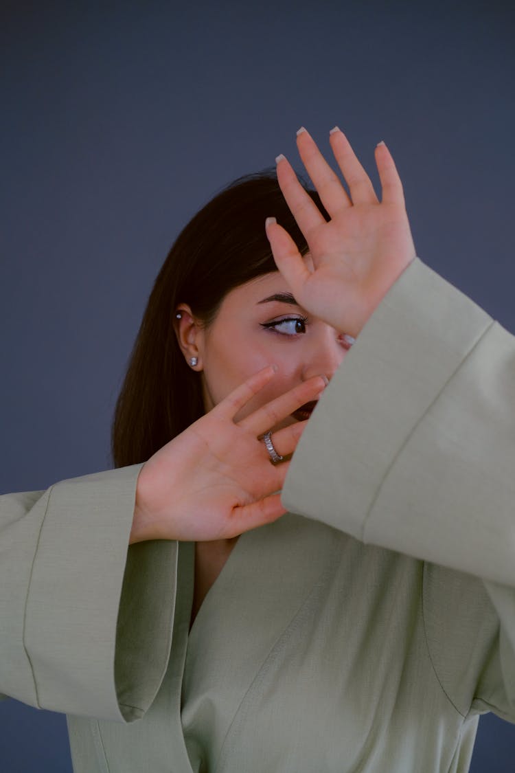 Woman Blocking The View Of Her Face With Hands