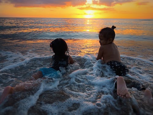 Photo of Two Girls in Beach during Golden Hour