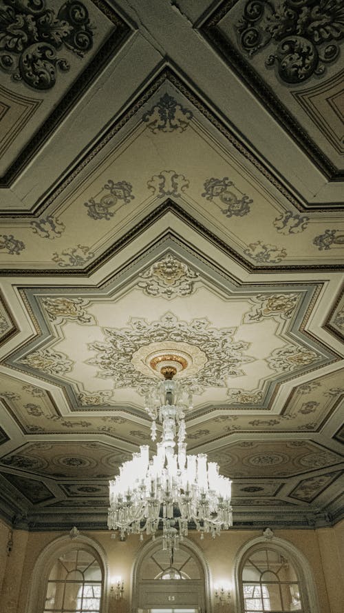 A Chandelier Hanging from a Ceiling with Intricate Designs