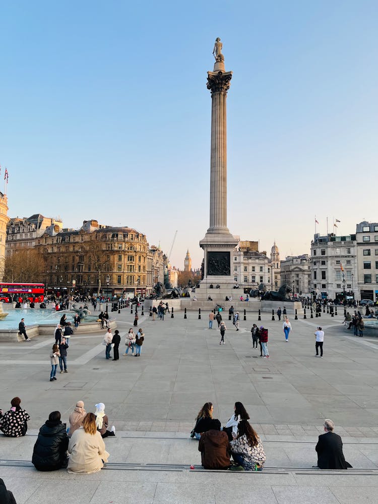 People On Square With Monument