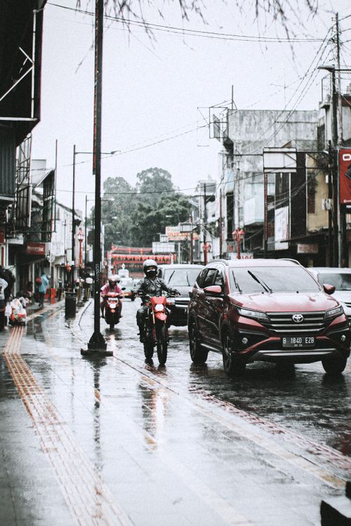 Free Traffic in West Java, Indonesia on a rainy day with cars and motorcycles. Stock Photo