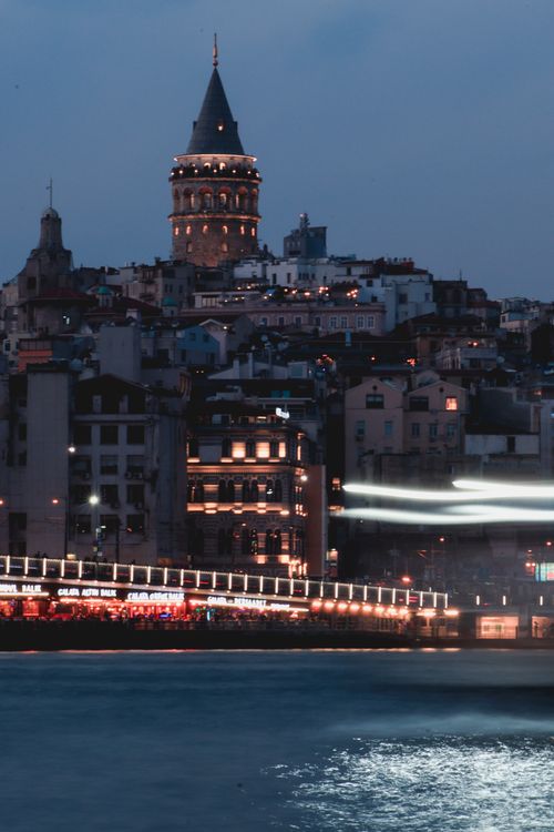 Free Night view of the Galata Tower illuminated with a cityscape background in Istanbul, Turkey. Stock Photo
