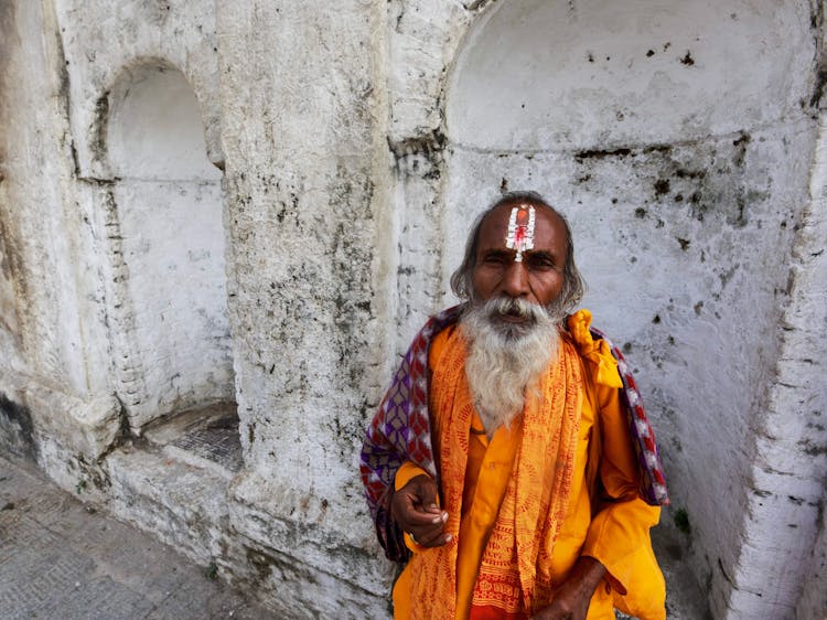 A Man In Traditional Clothing And A Tilaka On The Forehead