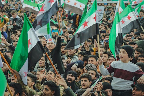 People holding Syrian Flag 