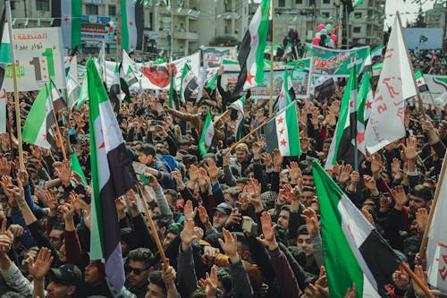 Free Rallying of People while holding Syrian Flag  Stock Photo