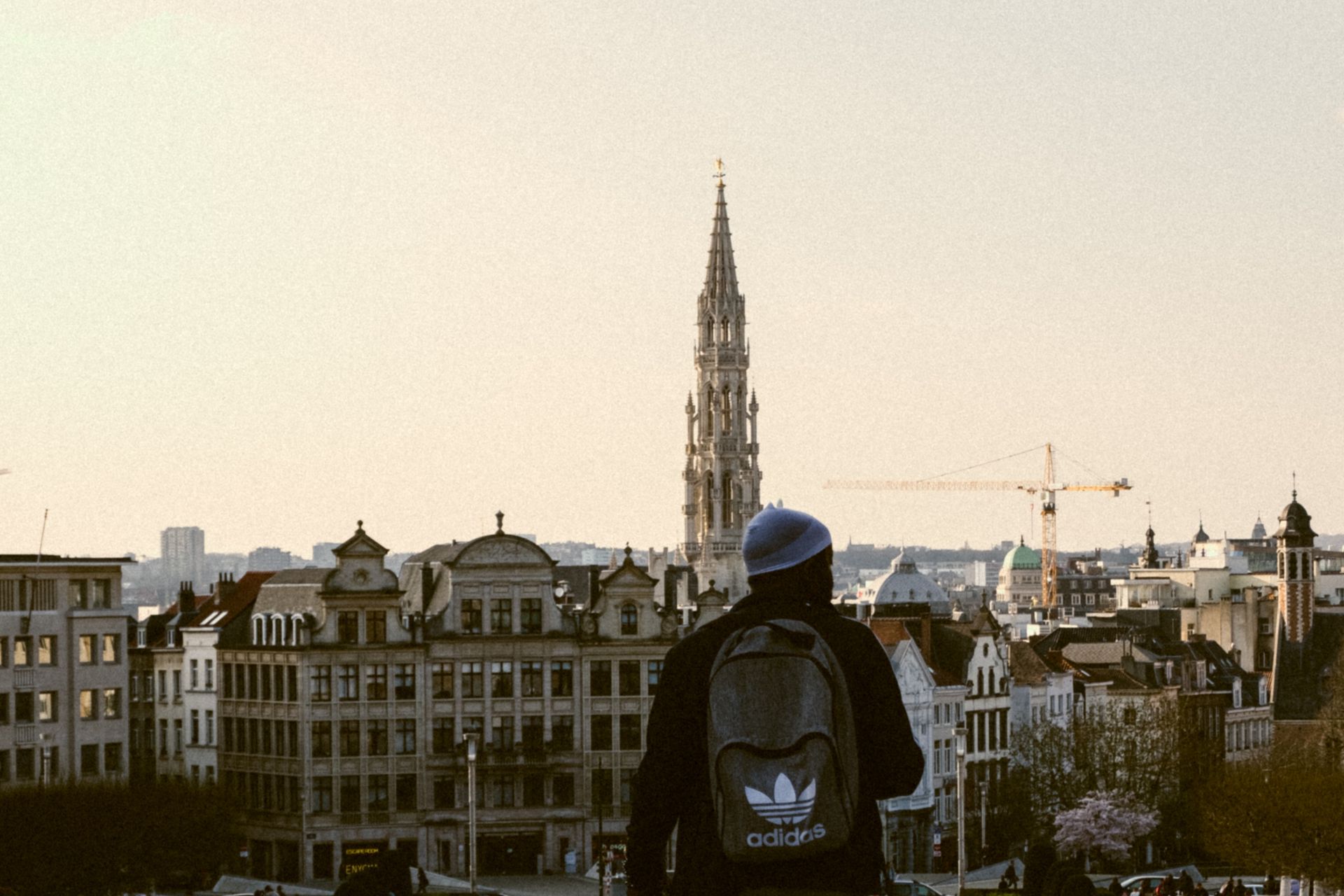 Back View of a Person Wearing Gray Beanie Hat and Adidas Backpack