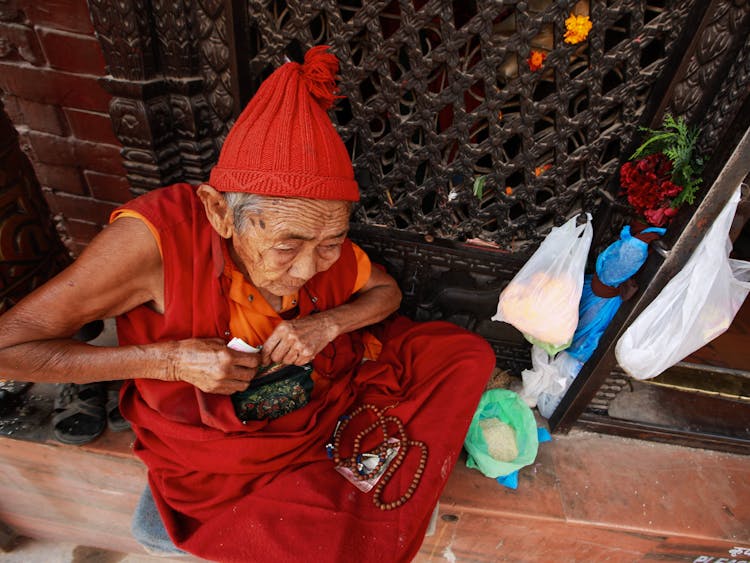 Elderly Monk By Temple