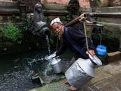 Elderly Man fetching Water using Metals Jars