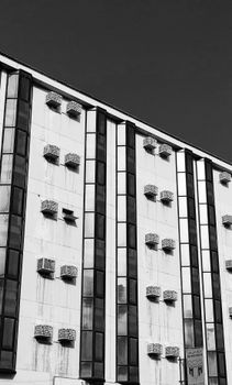 Black and white photo of a modern building facade with geometric patterns.