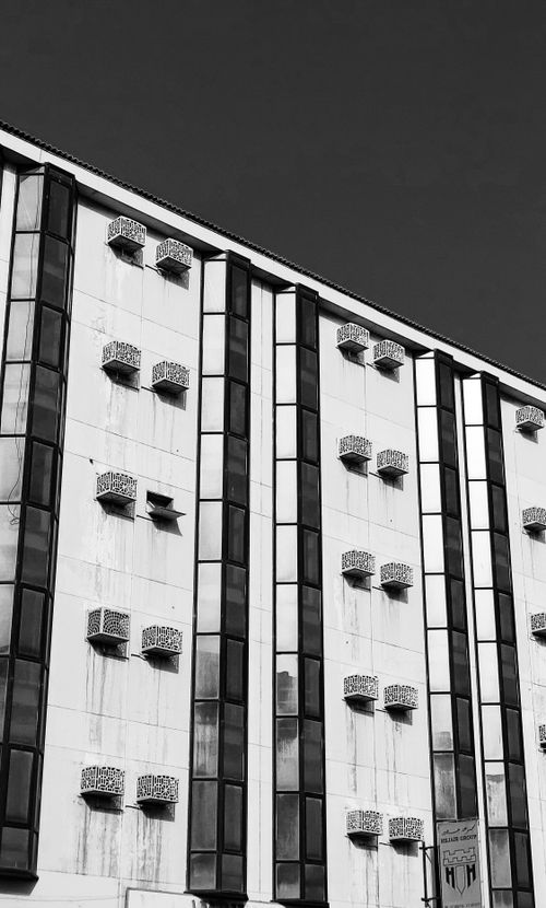 Free Black and white photo of a modern building facade with geometric patterns. Stock Photo