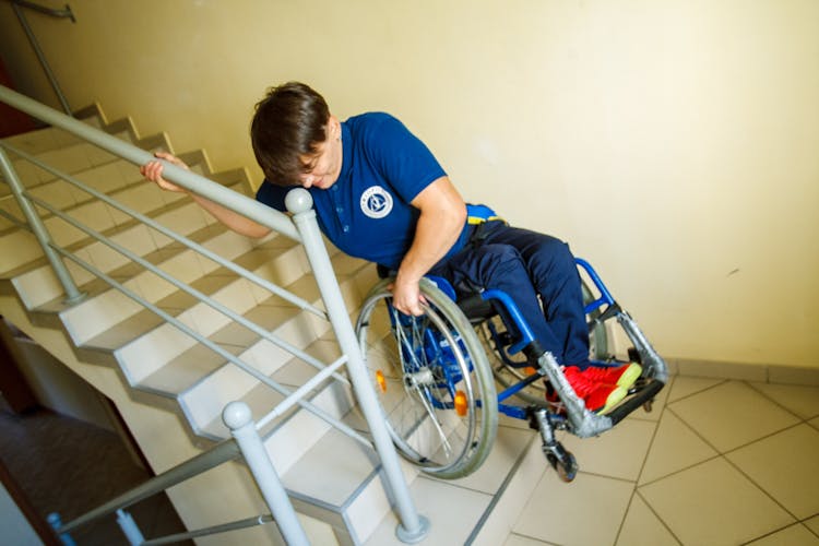 Person In A Wheelchair Going Down The Stairs