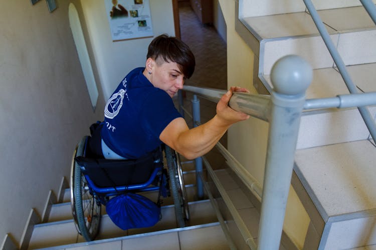 Person In A Wheelchair Going Down The Stairs