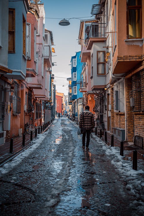 A Person Walking on Wet Road