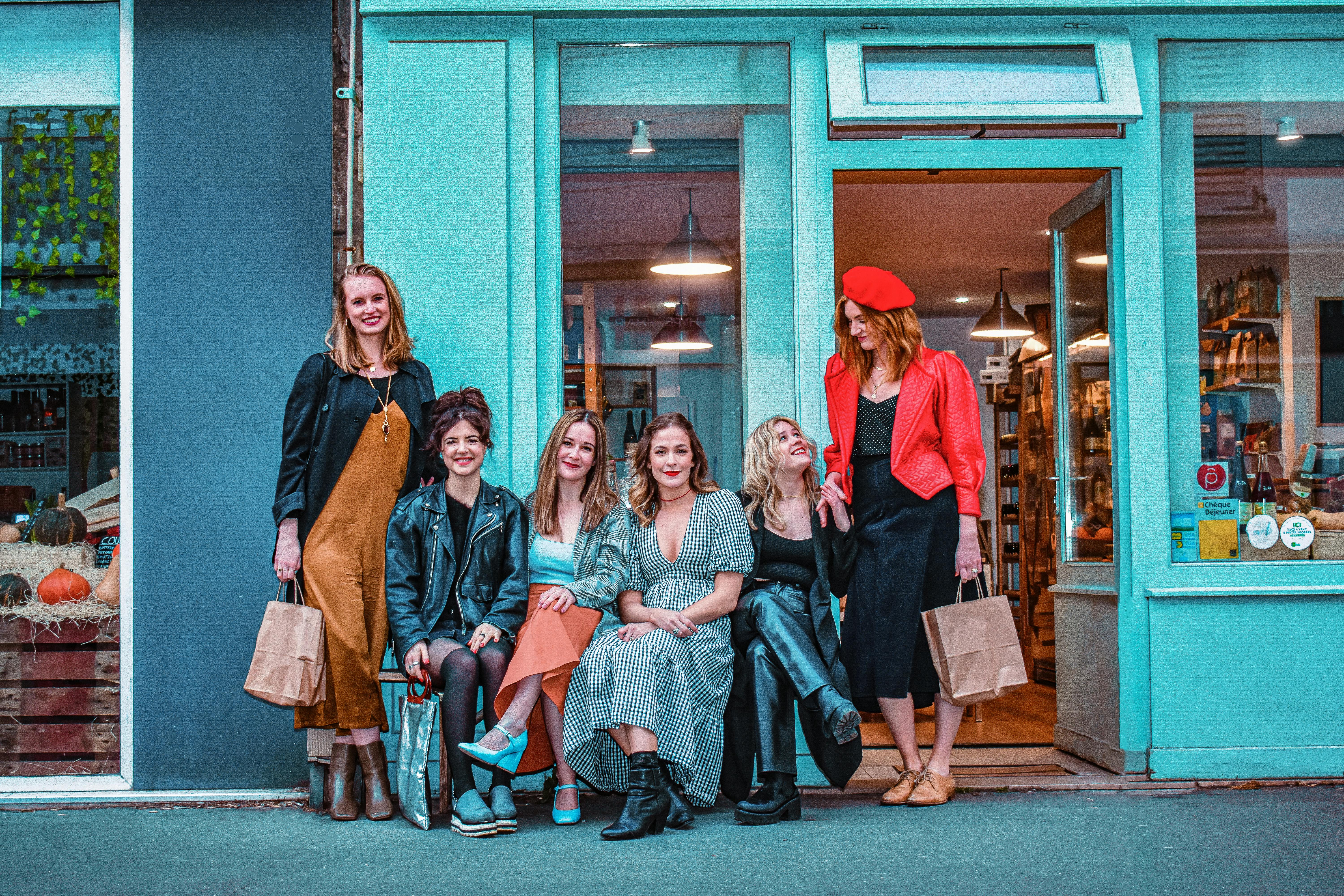 a group of stylish women outside the store front