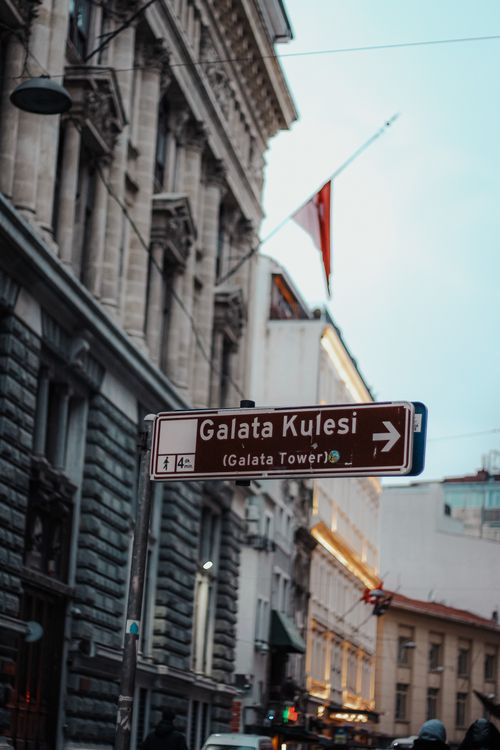 Free A street sign directing to Galata Tower in the vibrant streets of Istanbul, Turkey. Stock Photo