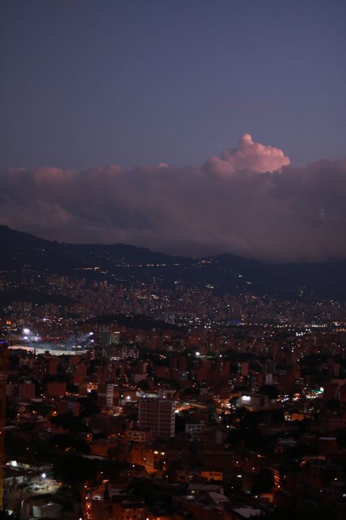 Free Stunning view of a densely populated cityscape illuminated at twilight. Stock Photo
