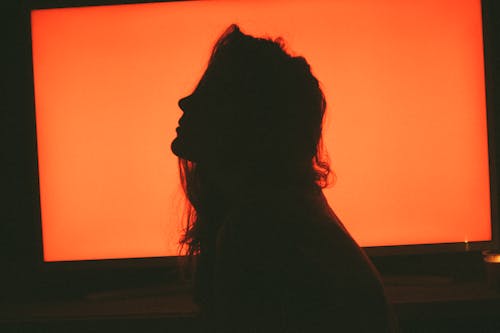 Free Silhouette of Woman in Front of Orange Wall Stock Photo